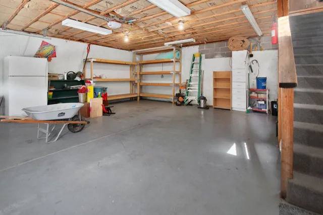 Garage with shelving, tools and open floor space