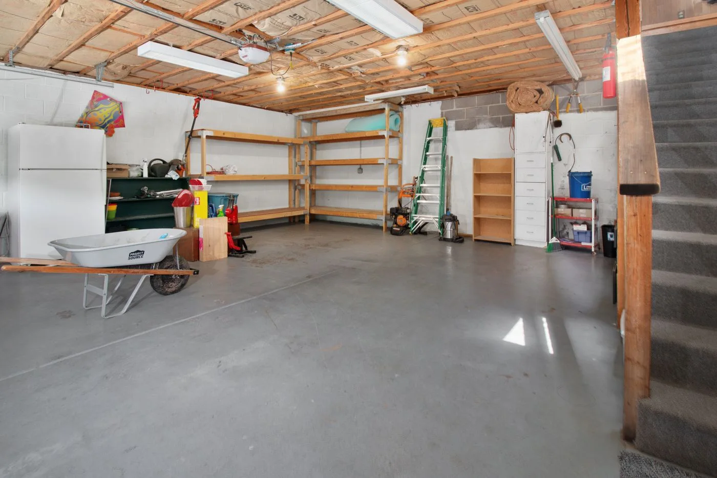 Garage with shelving, tools and open floor space