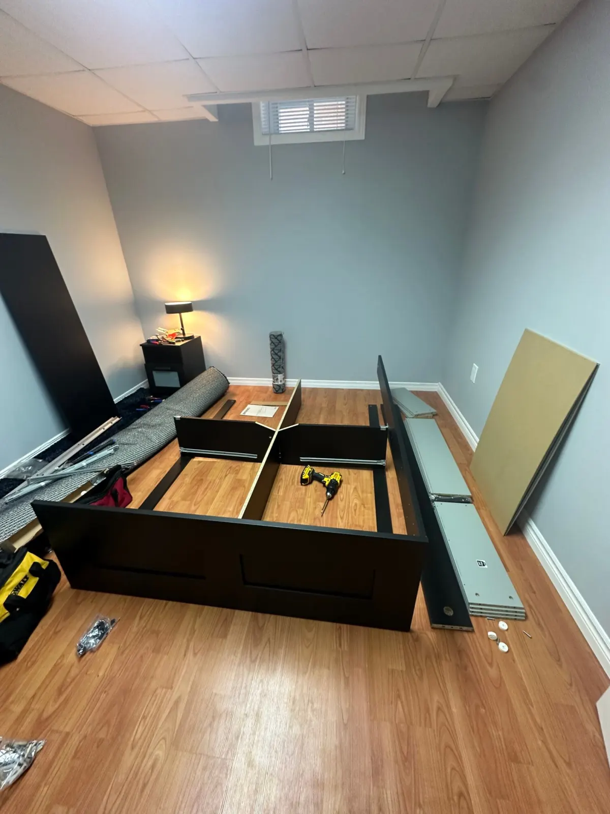 Bed frame being assembled in a room