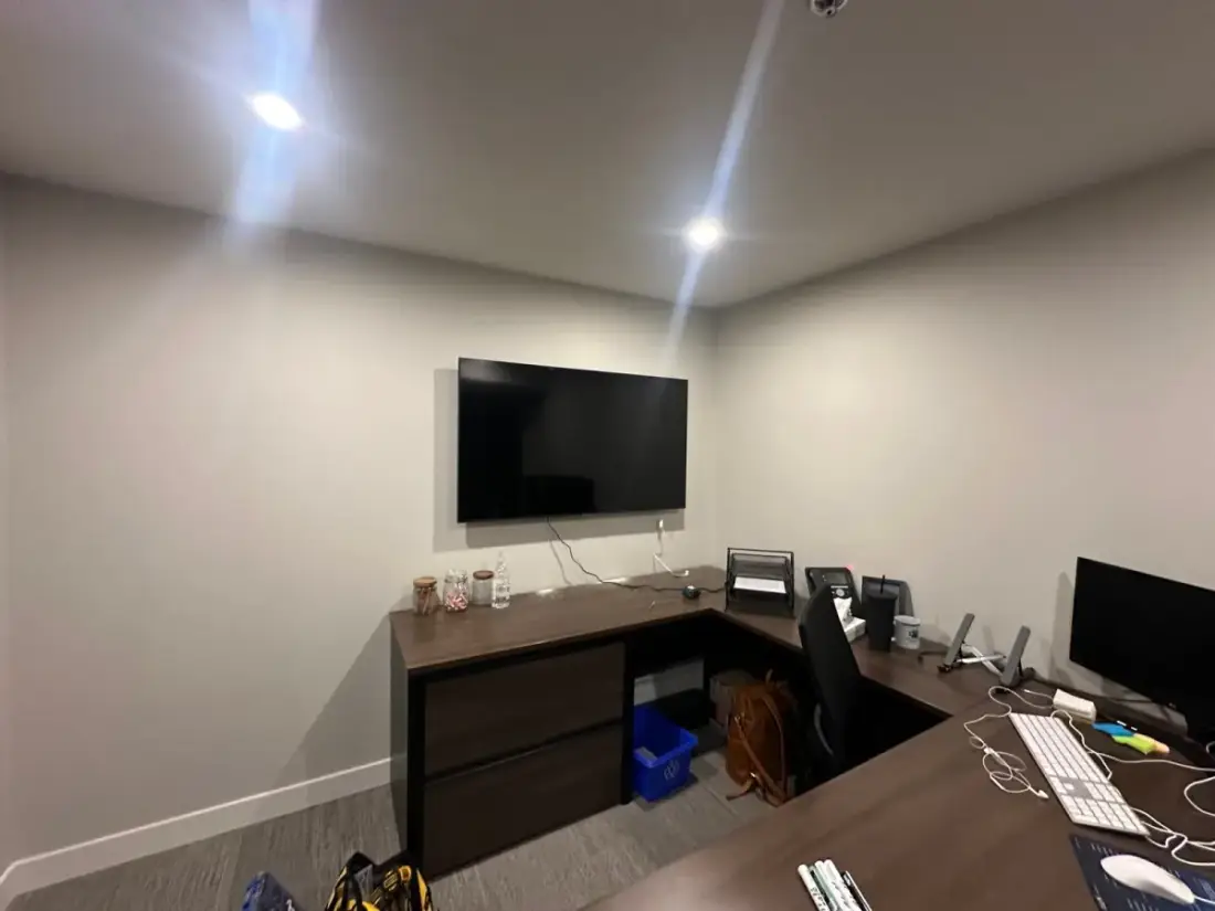 A TV mounted above an office desk